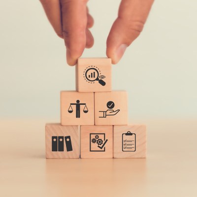 Hand stacks wooden cubes with symbols